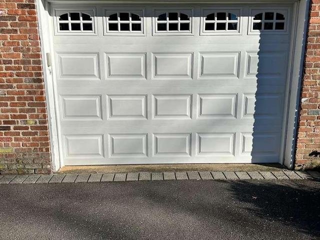 White garage door with arched windows