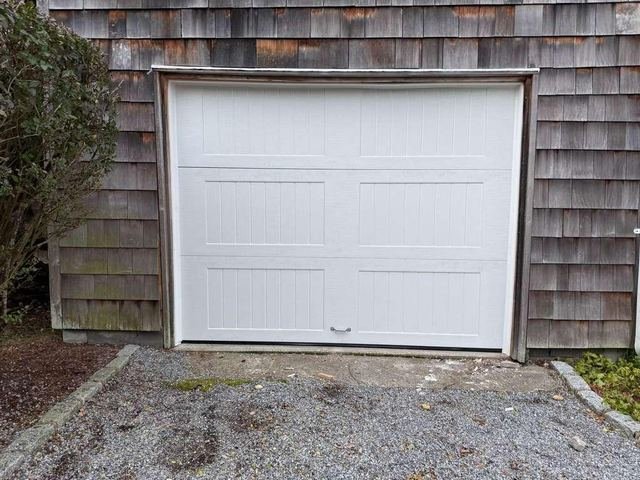 Carriage style garage door on a cedar shingle home