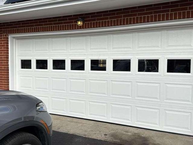 Double garage door with windows on a brick home
