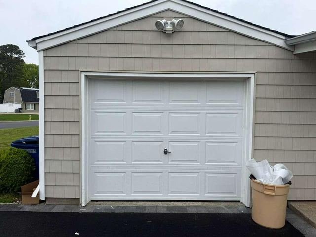 White garage door on a tan home after service