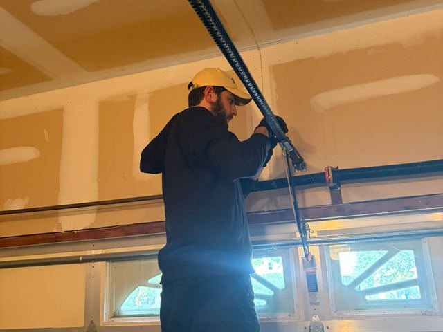 Pro Line technician repairing a garage door opener